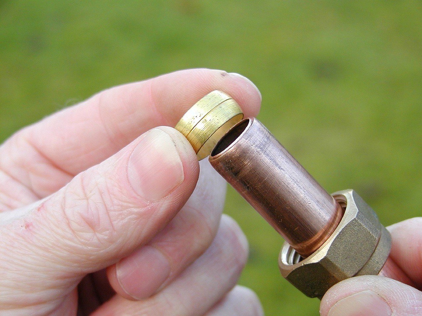 Close-up of copper plumbing fittings during a repair